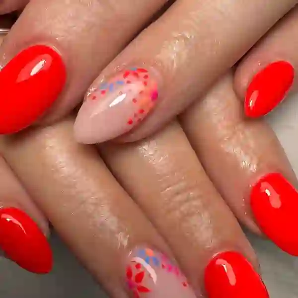 Vivid red gel nails with floral nail art at The Nail Beautique Stockport